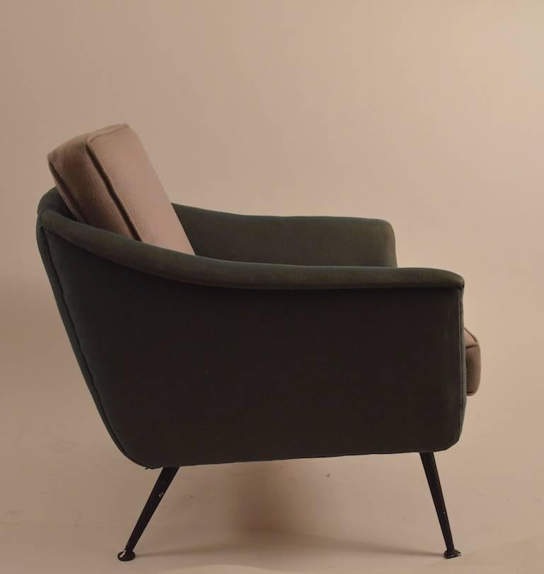 Swedish Modern upholstered lounge chair, on painted black metal legs (paint shows wear). This chair can be used with, or without the backrest cushion, as shown. 
The chair will need to be reupholstered before use - we have also listed the matching