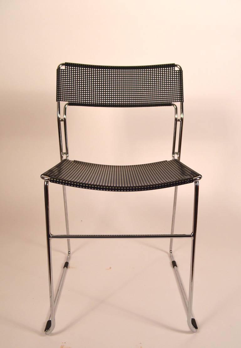 Classic post modern rationalist design chair, perforated black metal back rest and seat, bright chrome structure. Probably Italian design and production.