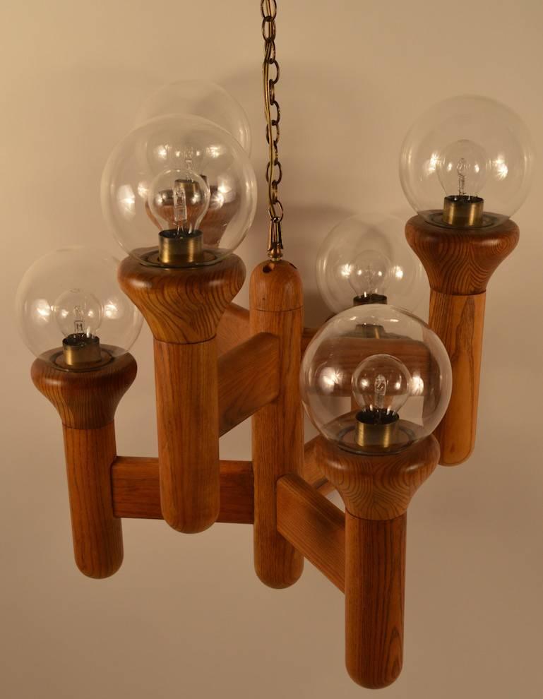 American in the Danish style, six-arm hanging fixture. Solid wood body, with glass ball shades. Fixture 24