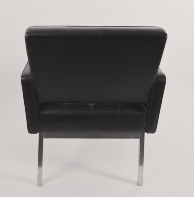 Pair of stylish International style armchairs, vinyl on squared aluminium bases. One chair has a 