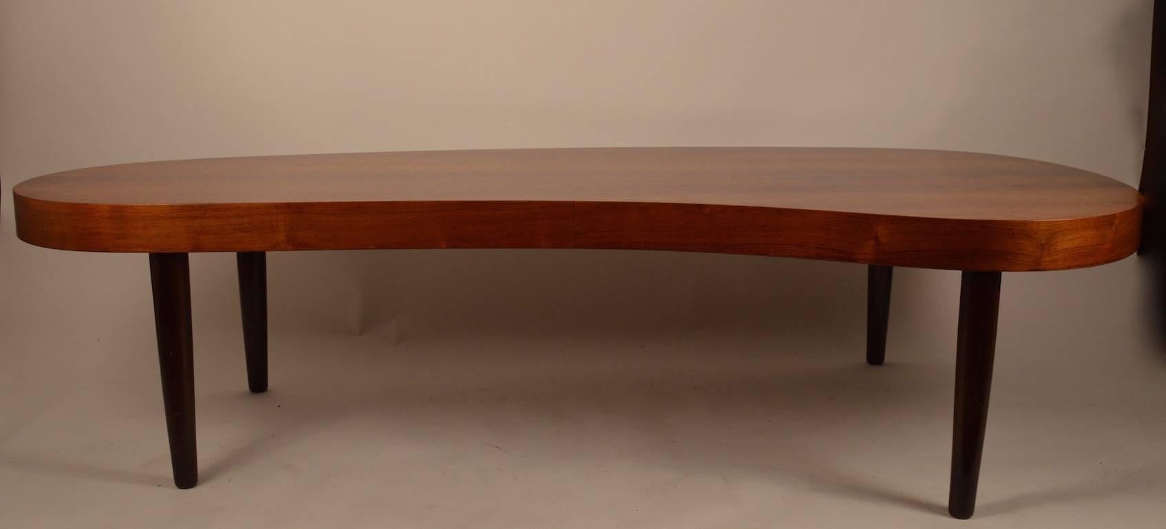 Great long free-form coffee table with bleached rosewood top and dark rosewood legs. Period 1940s after classic Rohde design. 3