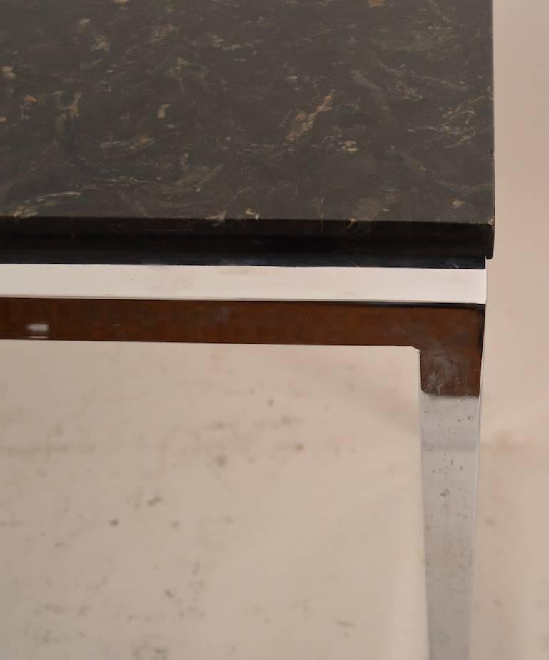 Bright squared chrome base supports black marble top. Top shows very light surface scratches, as shown.