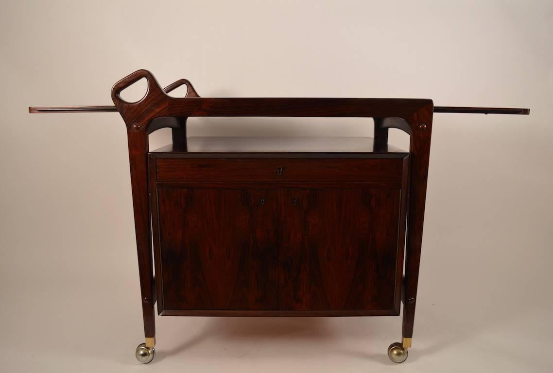 Rosewood serving, bar cart. Danish made, this example has a drop leaf top, which, when extended creates a large work surface (53.25