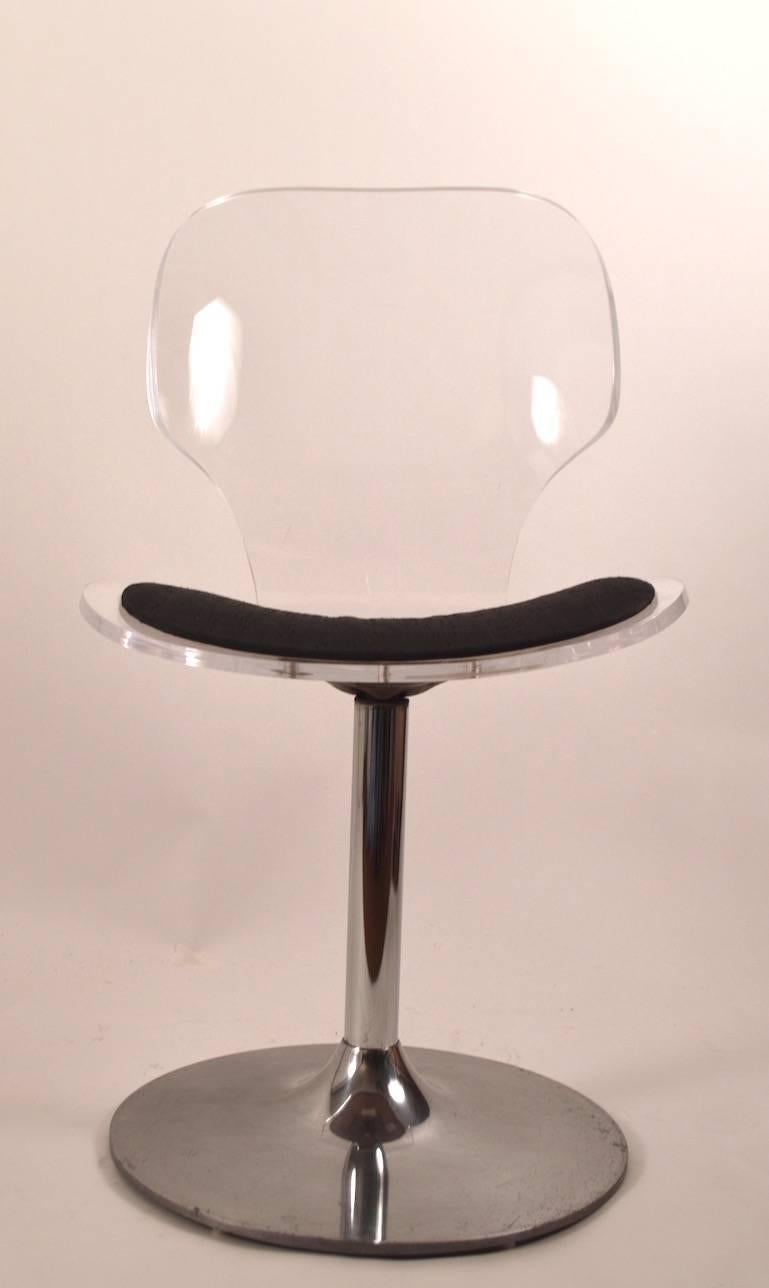 Thick Lucite seat and back, original black fabric pad seat (minor stains), chrome pedestal base. Made by 