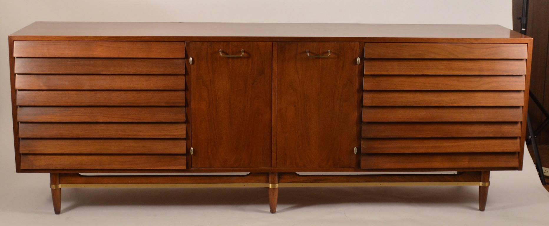 Very nice example of the work of Merton Gershun for American of Martinsville. Two banks of louvered drawers flank doors which open to storage drawers. Very fine original condition, showing only very minor cosmetic wear. Clean ready to use, great