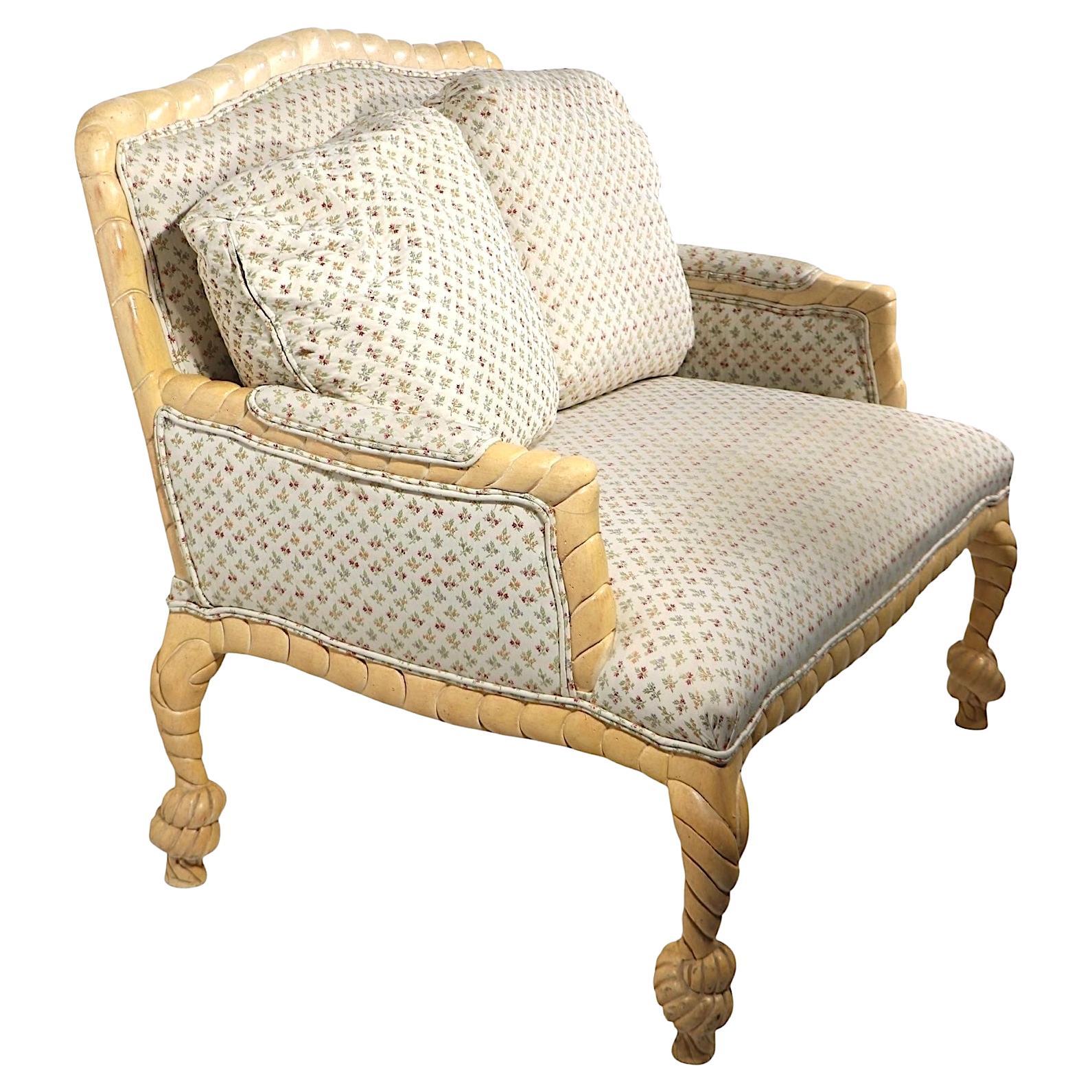 Chic, stylish loveseat, chair and a half form executed in the style of A M E Fournier, made in Italy circa 1960/70's. The sofa features the classic carved wood rope tassel frame, with elegant upholstery, including two down filled back cushions. This