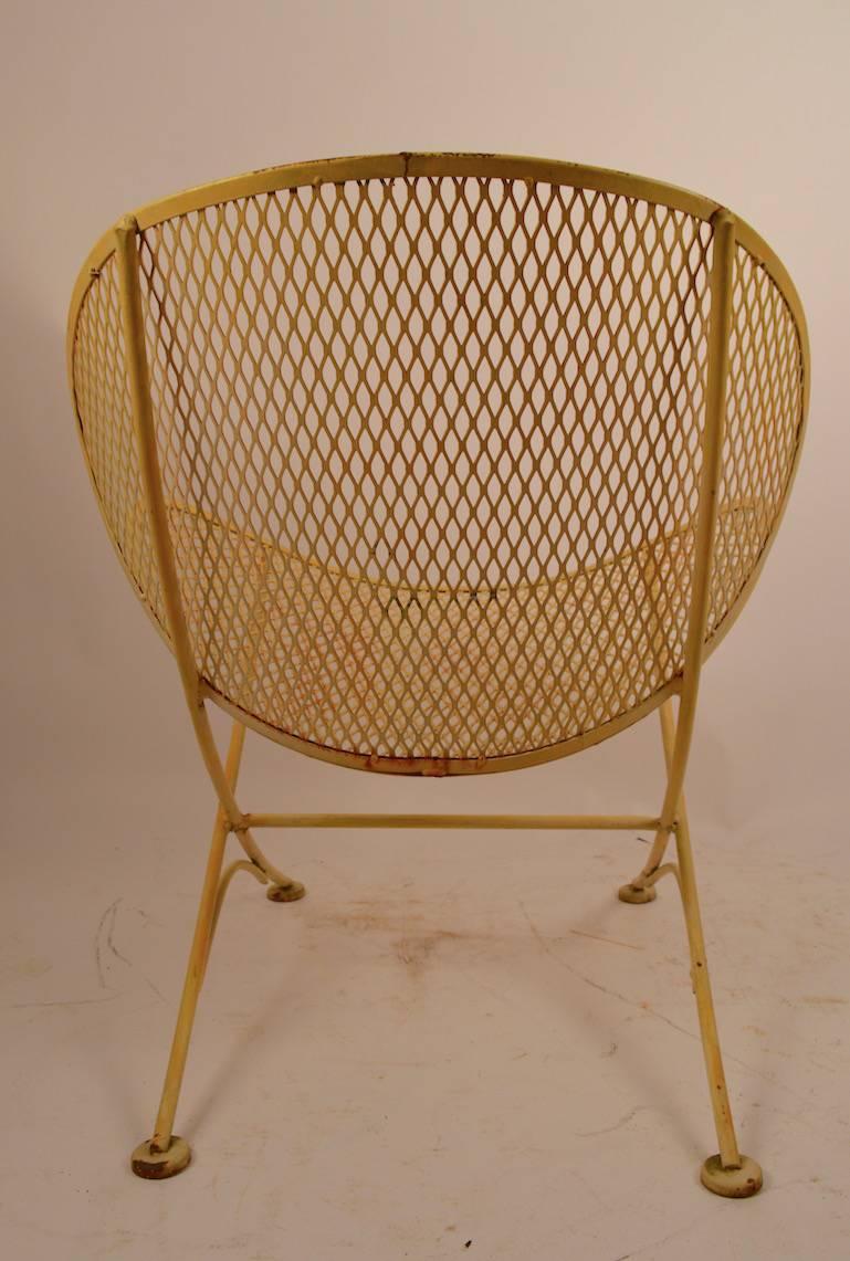 Classic Tempestini design for Salterini. Metal mesh seat and back, on wrought iron frame. Currently in original yellow paint finish which shows wear normal and consistent and age. 