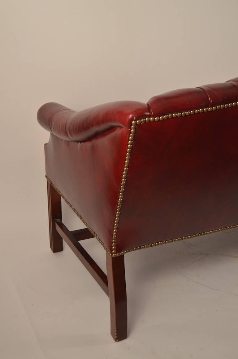 Mid-20th Century Burgundy Leather Chippendale Camelback Sofa