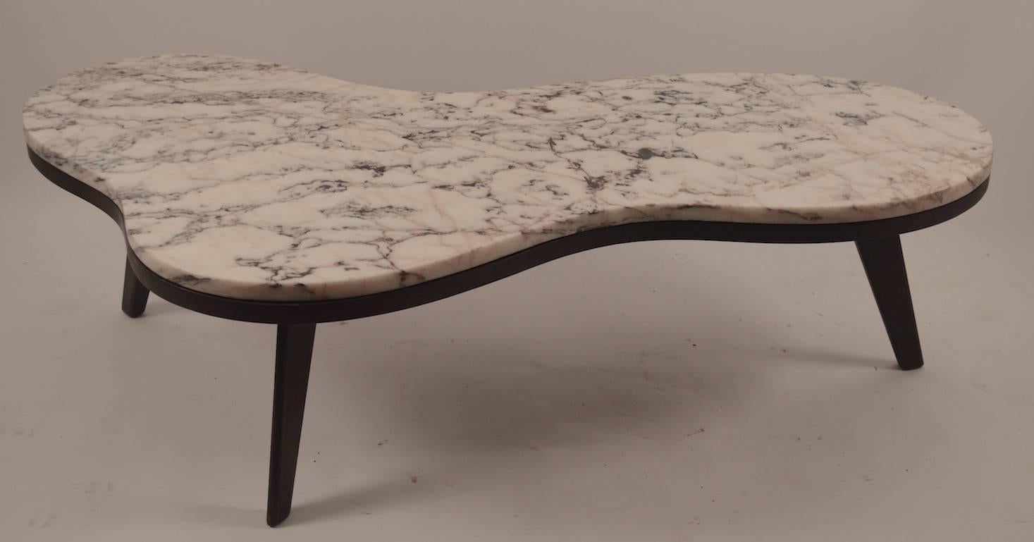 Large marble top coffee, cocktail table, after Robsjohn Gibbings. This table can be used with the marble top, or without as shown. Large amoeba shape top rests on three splayed wood legs. Marble top has an insignificant chip along the edge, as shown