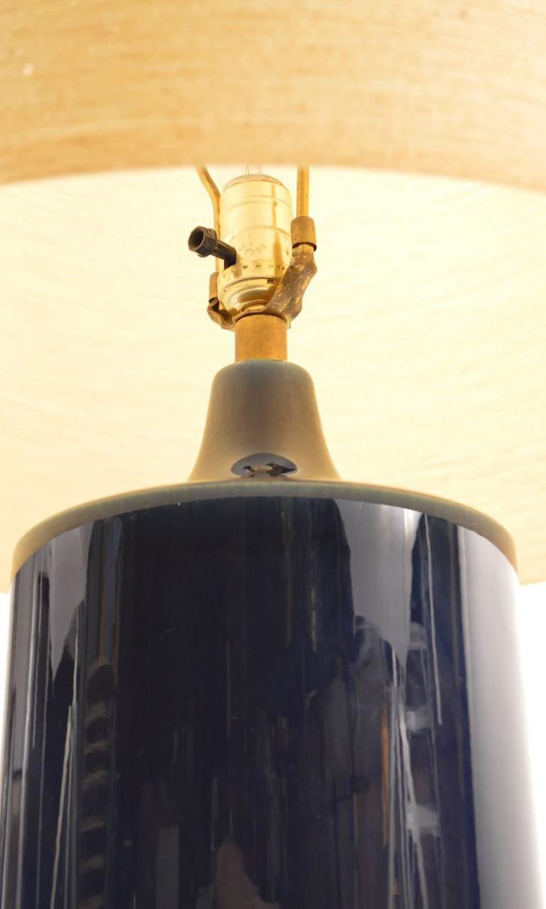 Wonderful cylindrical blue glaze Lotte Bostlund ceramic lamp with original shade. Great original working condition, one of three Lotte lamp we are listing from the same estate. The closeup shots are the true color of the lamp. Height to top of