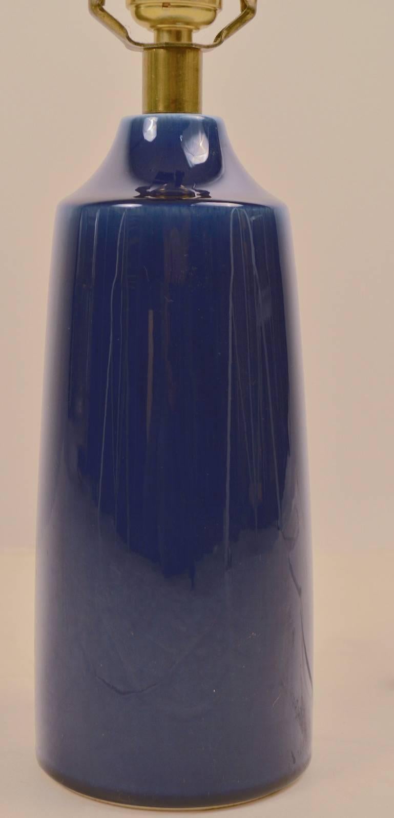 Cylindrical ceramic lamp in blue with original shade by Lotte, Boslund. Great, original, working condition, one of three we are listing from one estate. Height to top of socket 13
