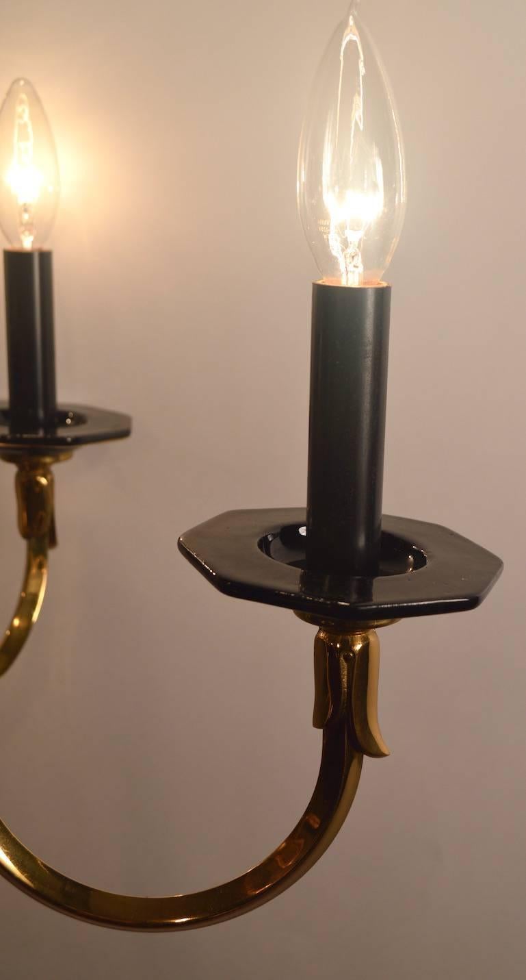 Hollywood Regency Six-Light Candle Style Black and Brass Chandelier For Sale