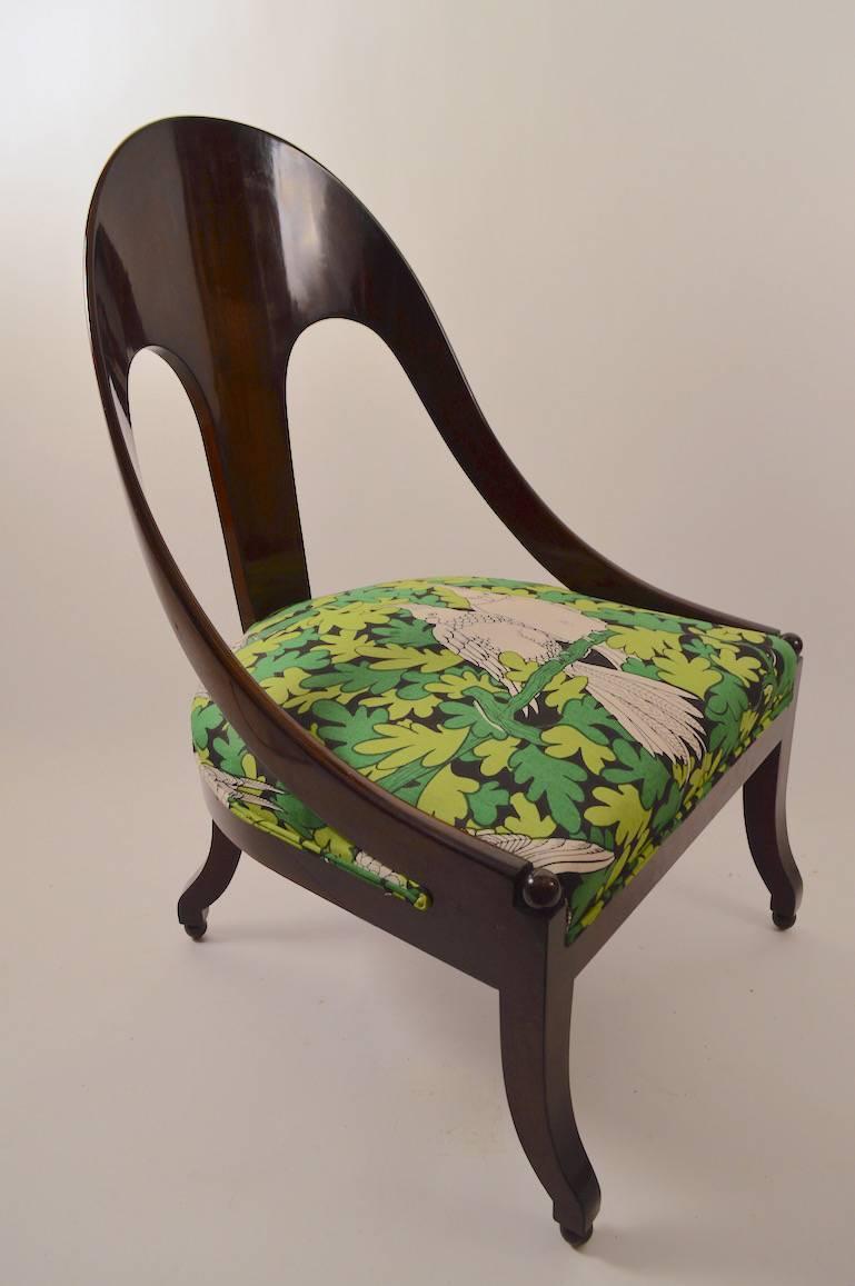 Michael Taylor design for Baker Furniture spoon back Regency style lounge chairs in very good original condition. Playful green foliate with birds upholstery, dark wood finish.