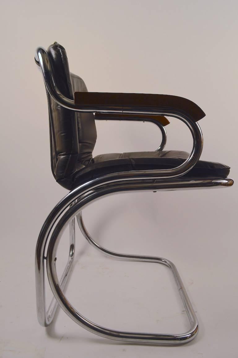 Tubular chrome frames, vinyl seat pad, wood armrests. These chairs are in the manner of Italian designer Gastone Rinaldi, however are probably American production. Stylish clean, ready to use condition.