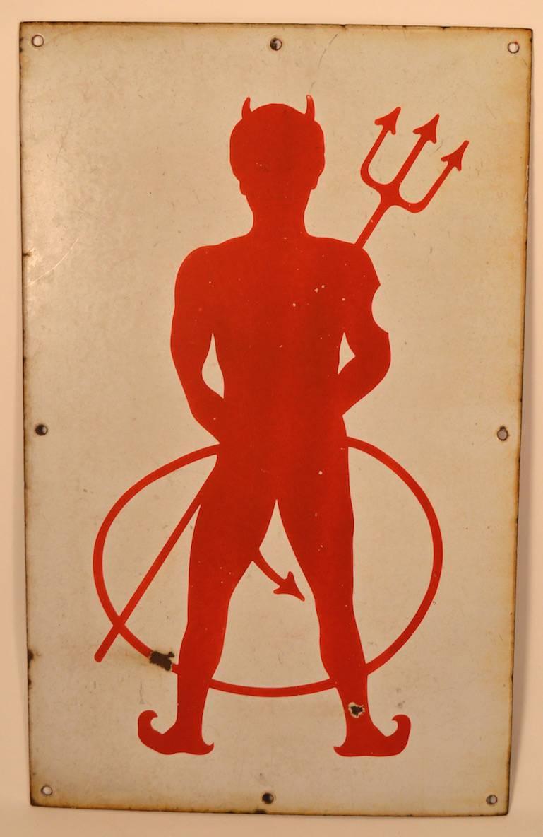 Interesting vintage porcelain advertising sign depicting a red devil with pitchfork, in red on cream background. Minor blemishes to surface, as shown, normal and consistent with age. Fun decorative sign, probably 1930s vintage.