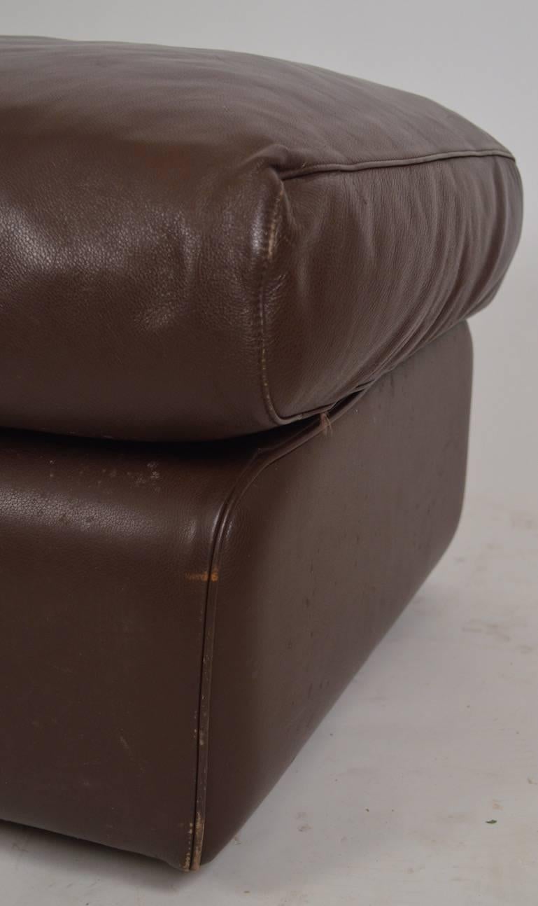 Footrest, ottoman by Poltrona Frau in chocolate leather. Comfy and supple, excellent quality leather, shows minor wear, normal and consistent with age.
