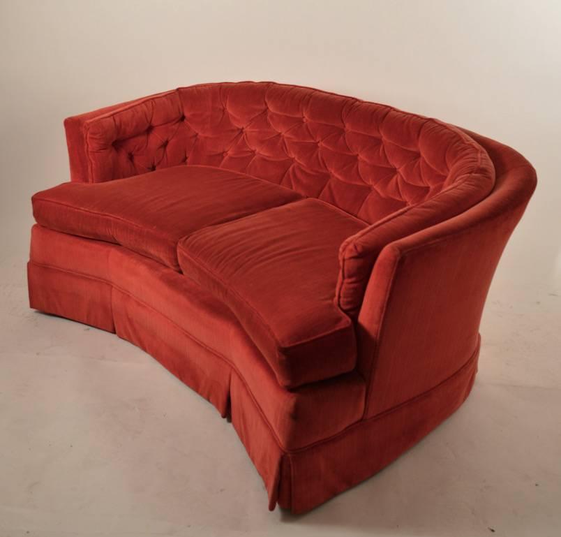 C-shape loveseat, sofa, in original red fabric, fabric shows wear. Structurally sound and sturdy frame.