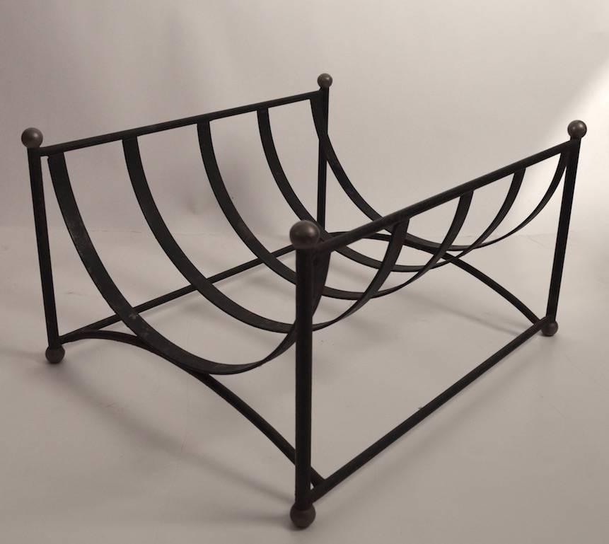 Iron log holder or magazine holder with ball finials and feet. Sturdy enough to use as log holder, diminutive enough to use as a magazine rack. This example shows some loss to the paint finish, normal and consistent with age.