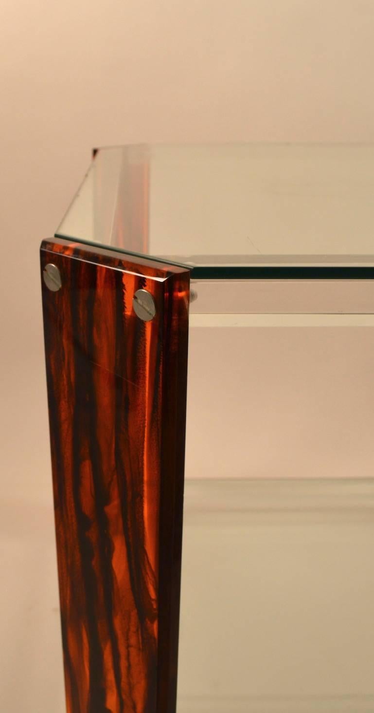 Stylish and unusual two-tier stand with faux tortoise shell Lucite legs, clear Lucite legs, and two plate glass shelves. Excellent clean, original condition. Suitable for use as an end table, lamp stand, or occasional table. Design and construction