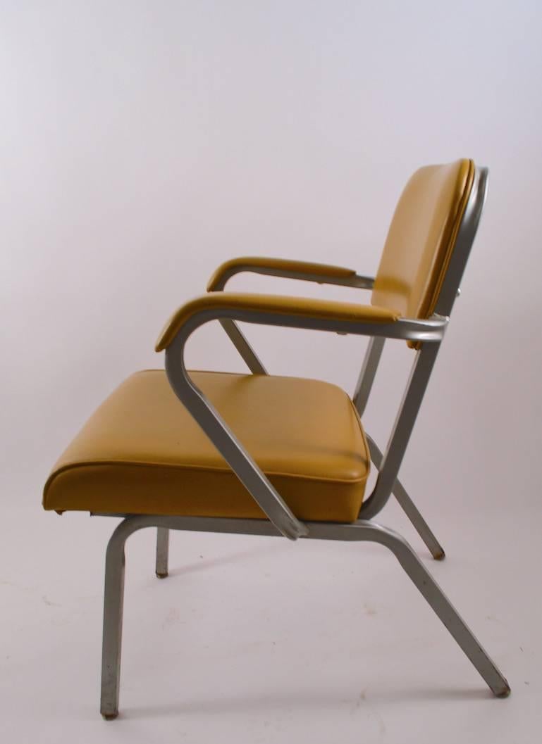 Machine Age style heavy gauge steel frames, original mustard color vinyl upholstery (shows minor wear). These chairs are constructed to commercial standards and can withstand heavy use. Arm height 26