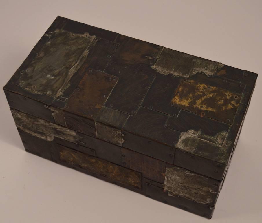 Brutalist patchwork mixed metal box by Paul Evans. Copper, brass and pewter surface with hinged flip open top and mustard felt interior.
 