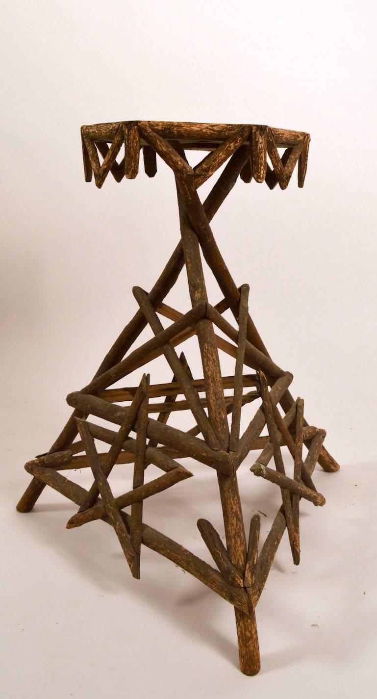 Interesting example of Adirondack twig furniture. This table has a five point star on each of the three sides. Measures: Top 12