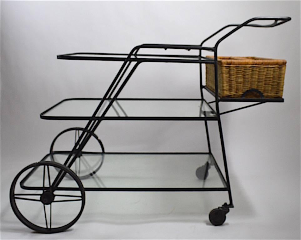 Wrought iron cart with plate glass shelves and wicker carry all basket. Nice large size serving cart of simple modern design. Shelves approximately 10