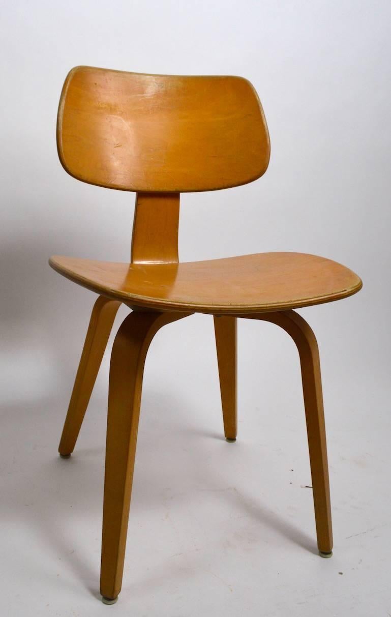 Classic Mid-Century bent plywood dining chairs by Thonet. Each shows cosmetic wear and scuffing, all are sturdy and solid. These chairs were produced to commercial standards and can withstand heavy use.