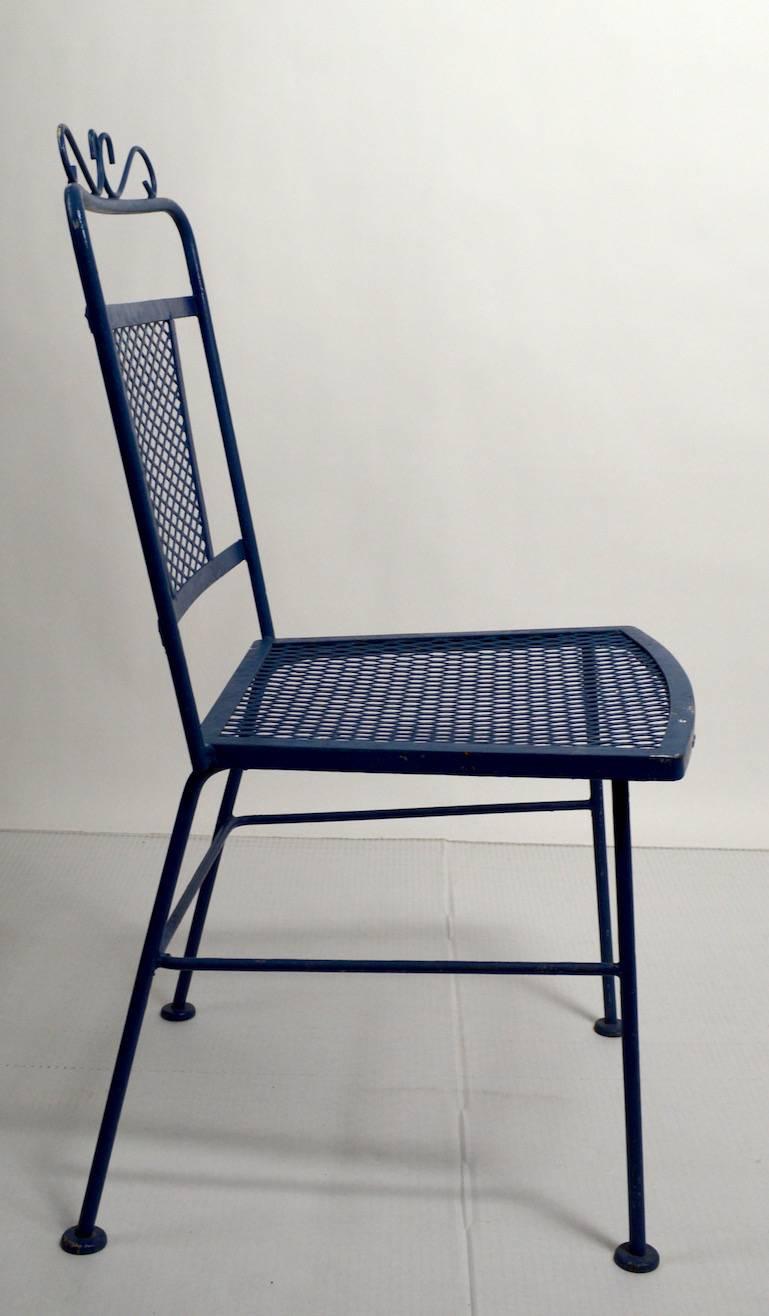 Four matching patio, garden dining chairs by Woodard. All chairs are in very good condition, showing only normal cosmetic wear. Iron and mesh construction, suitable for indoor or outdoor use.