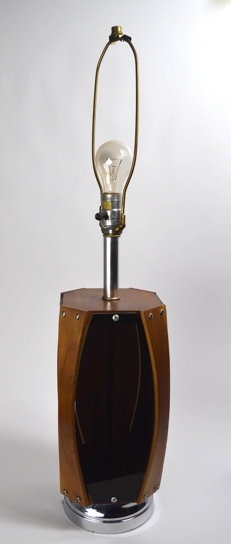 Pair of lamps manufactured by the Lawrin Lamp Company featuring a light up interior option in addition to the standard bulb at the top. The interior lights can be operated independently from the top bulb, making it possible to use the lights in
