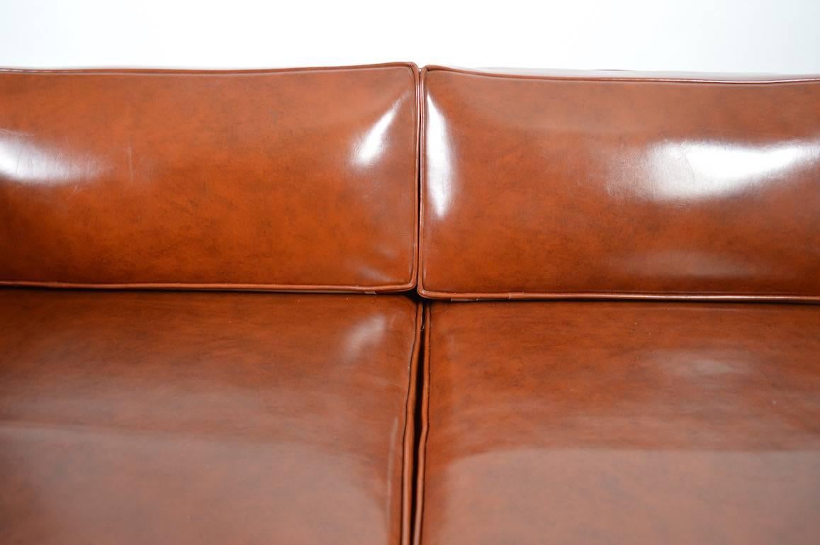 Vinyl upholstery box sofa with sculpted Kagan style wood legs. Extra clean, original condition, well built couch, ready to use.
