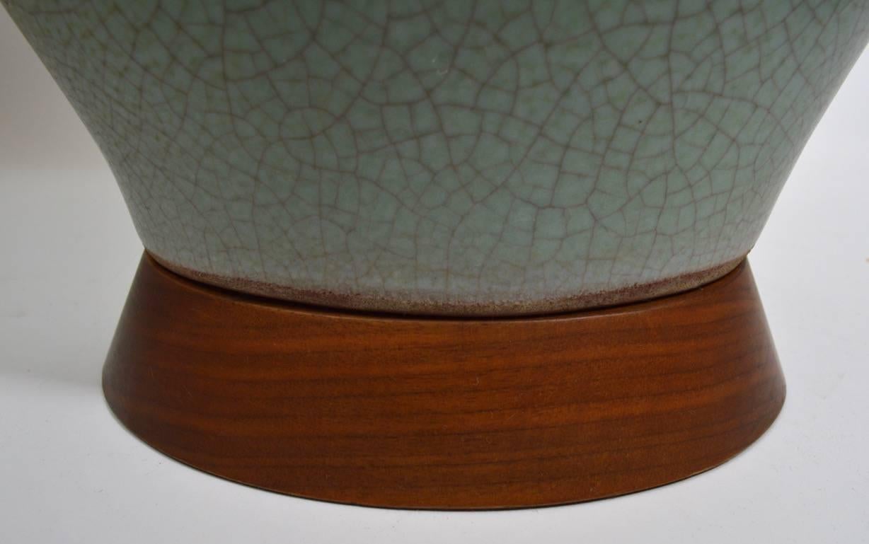 Ovoid form Celadon color crackle glaze table lamp on oval wood base. Mid-Century homage to Classic Chines Celadon pottery. Working, clean, original, shade not included height to top of ceramic body 23