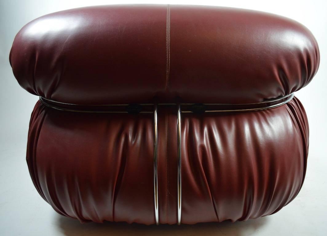 Designed by Afra and Tobia Scarpa for Cassina, made in Italy. This example is in an unusual Burgundy color leather, it is in great, original condition, and retains the original labels on the bottom.