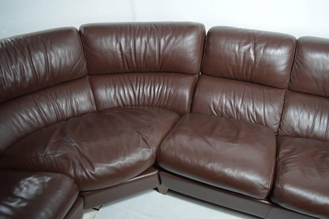 Large curved section sofa by Poltrona Frau, in rich chocolate leather.
Deep comfy seats, supple rich leather, sofa consists of three sections. One arm shows a stain (nail polish spill, from a celebrity Diva). Depth of seat 36