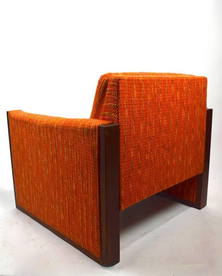 Modernist cube style club chair in original textured fabric with wood trim. This chair was built to commercial standards, with extra grade construction, style and comfort. The fabric is usable as is, showing only light cosmetic normal and consistent