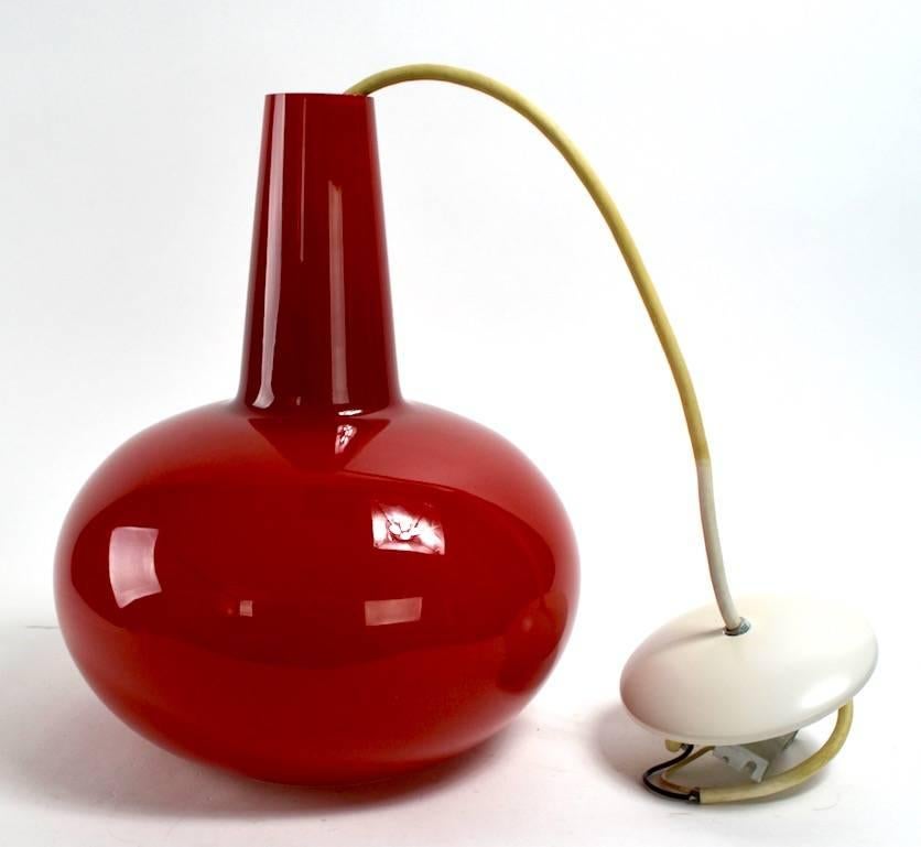 Deep rich red cased glass pendant light in teardrop form. We have two of these, red shades. We  have a total of eight  of these pendant lights in various colors, also listed separately. Please view our other listings if interested in multiples.

