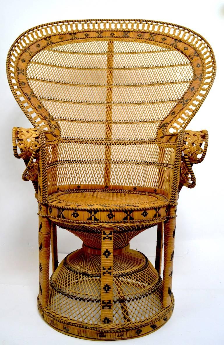 Classic Emmanuel peacock wicker, rattan chair. This example shows some minor wear, normal and consistent with age. Measures: Seat height 18, arm height 29. Clean, sturdy and ready to use.