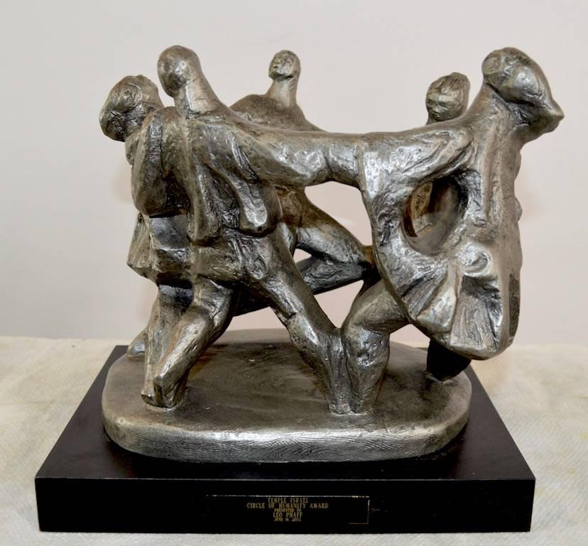 This interesting sculpture was given as an award to Leo Phaff by the Temple Israel 2002, it is marked Sever
(Kara Sever) Austin sculpture, entitled Circle of Humanity. The sculpture is cast plaster, and is in perfect condition.