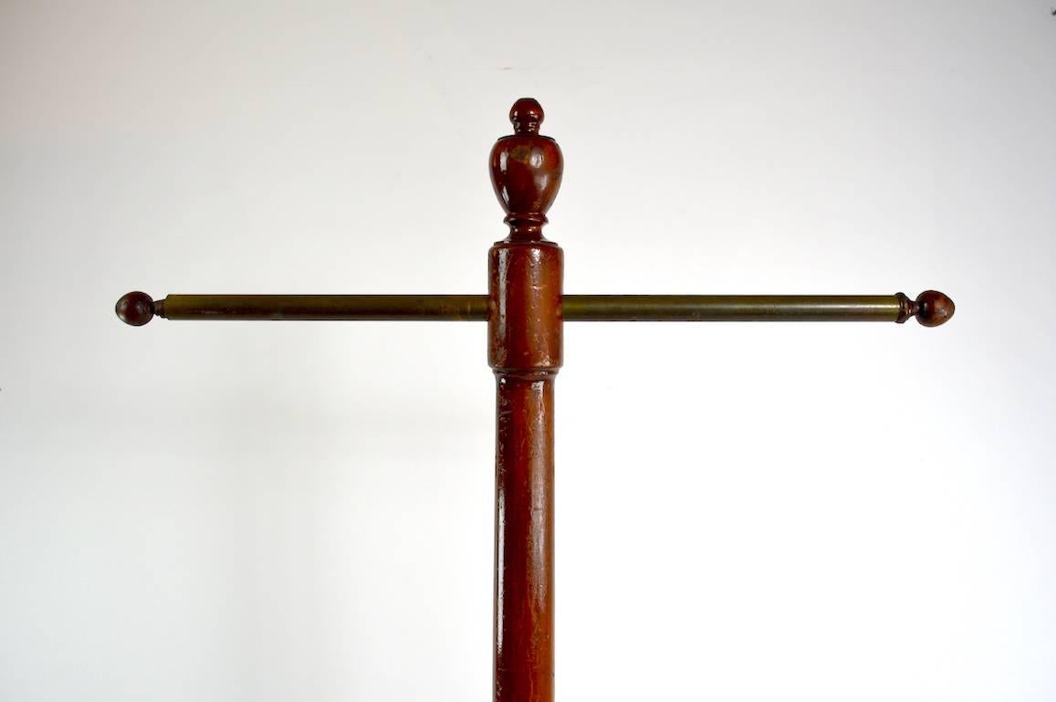 Solid wood coat tree, clothing display stand, with horizontal brass rod support. Turn of the century vintage, shows minor cosmetic wear, normal and consistent with age. Base 18 inches diameter, rod 26 inch length. Great for personal or commercial