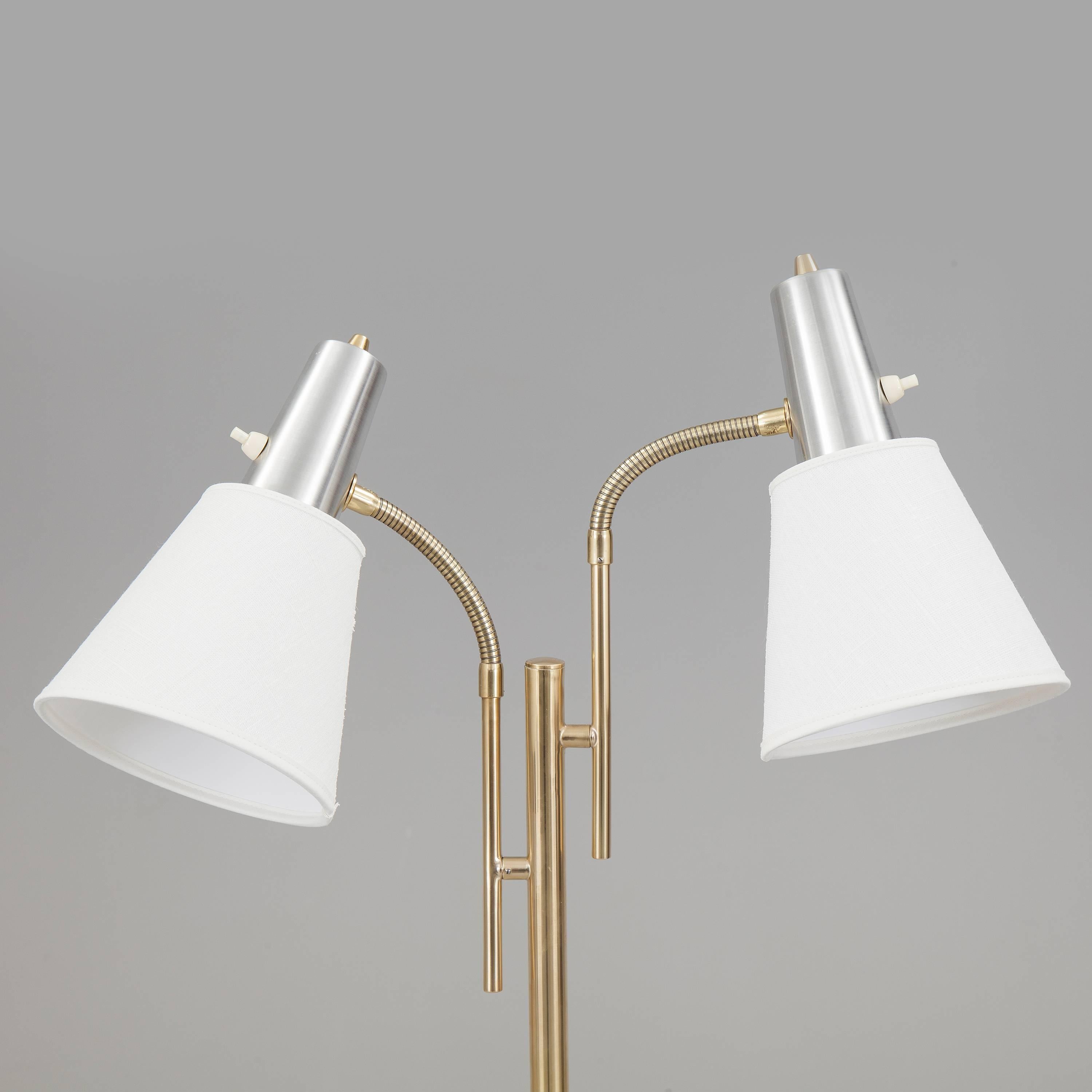 Elegant Modern Swedish floor lamp.
Orientable shade.
Manufactured, circa 1960.
Brass, aluminium, textile shade.