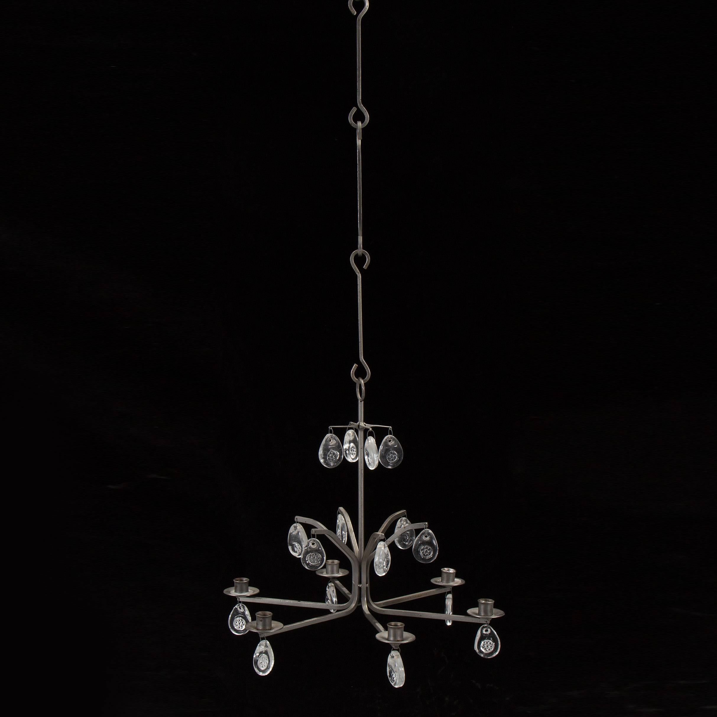 Erik Höglund lit chandelier; Sweden, circa 1950;
Produced by Boda Smide;
Wrought iron metal; glass.