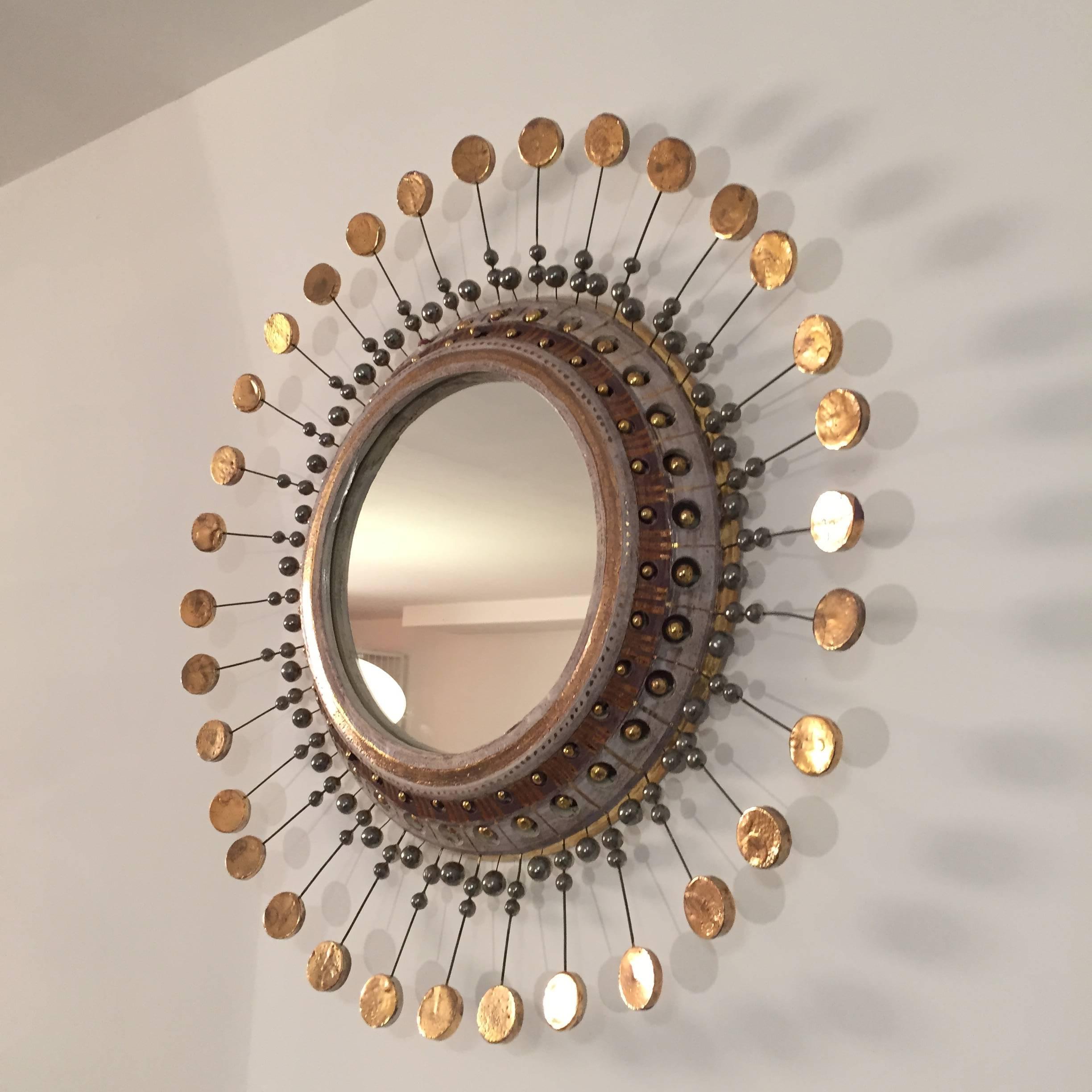 Beautiful sunburst mirror by Georges Pelletier in glazed ceramic.
Gold and silver details,
circa 1960.