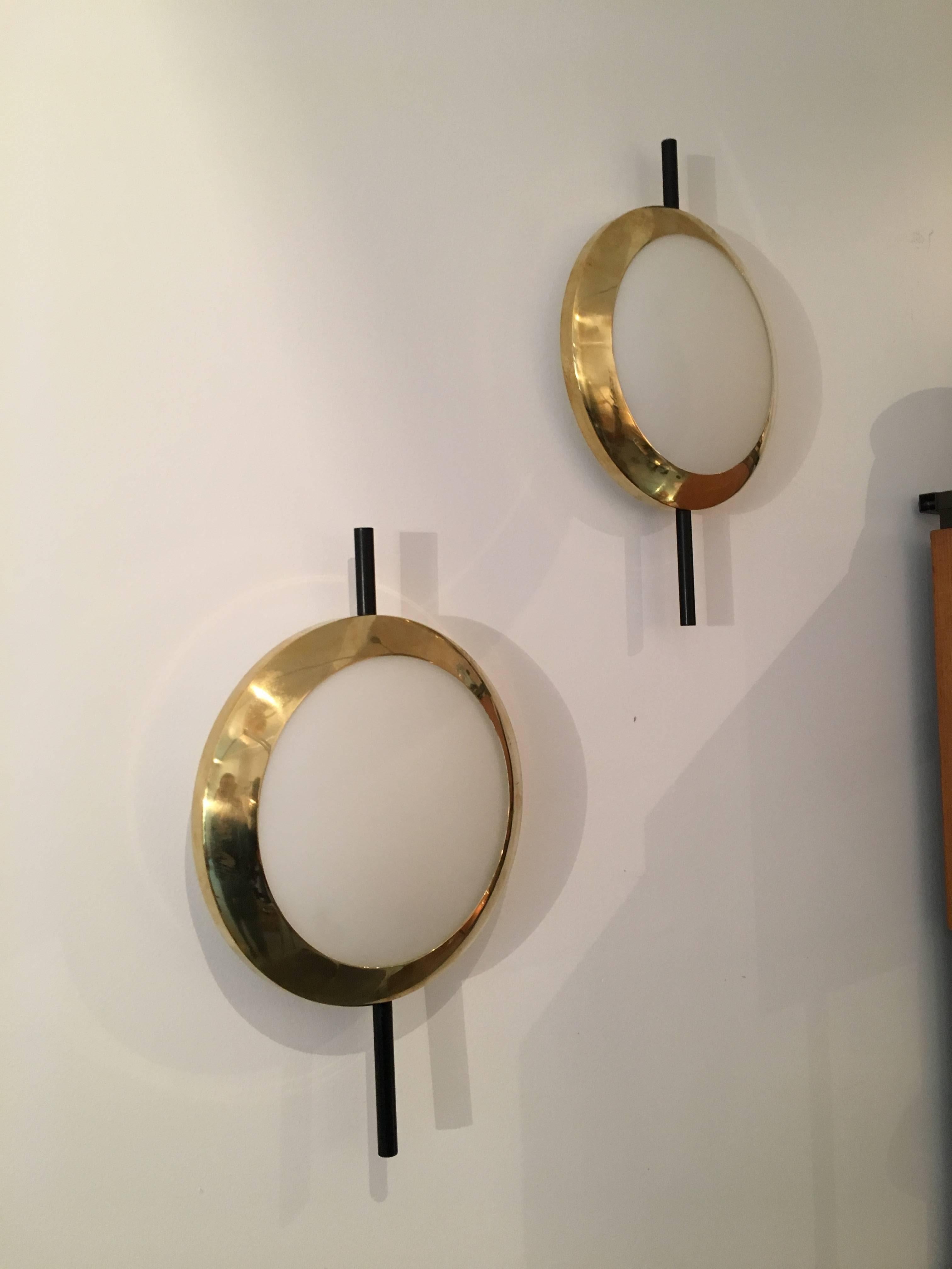 Pair of Wall lights in the style of Stilnovo;
Italy, circa 2000.
Brass, lacquered metal; opaline glass;.