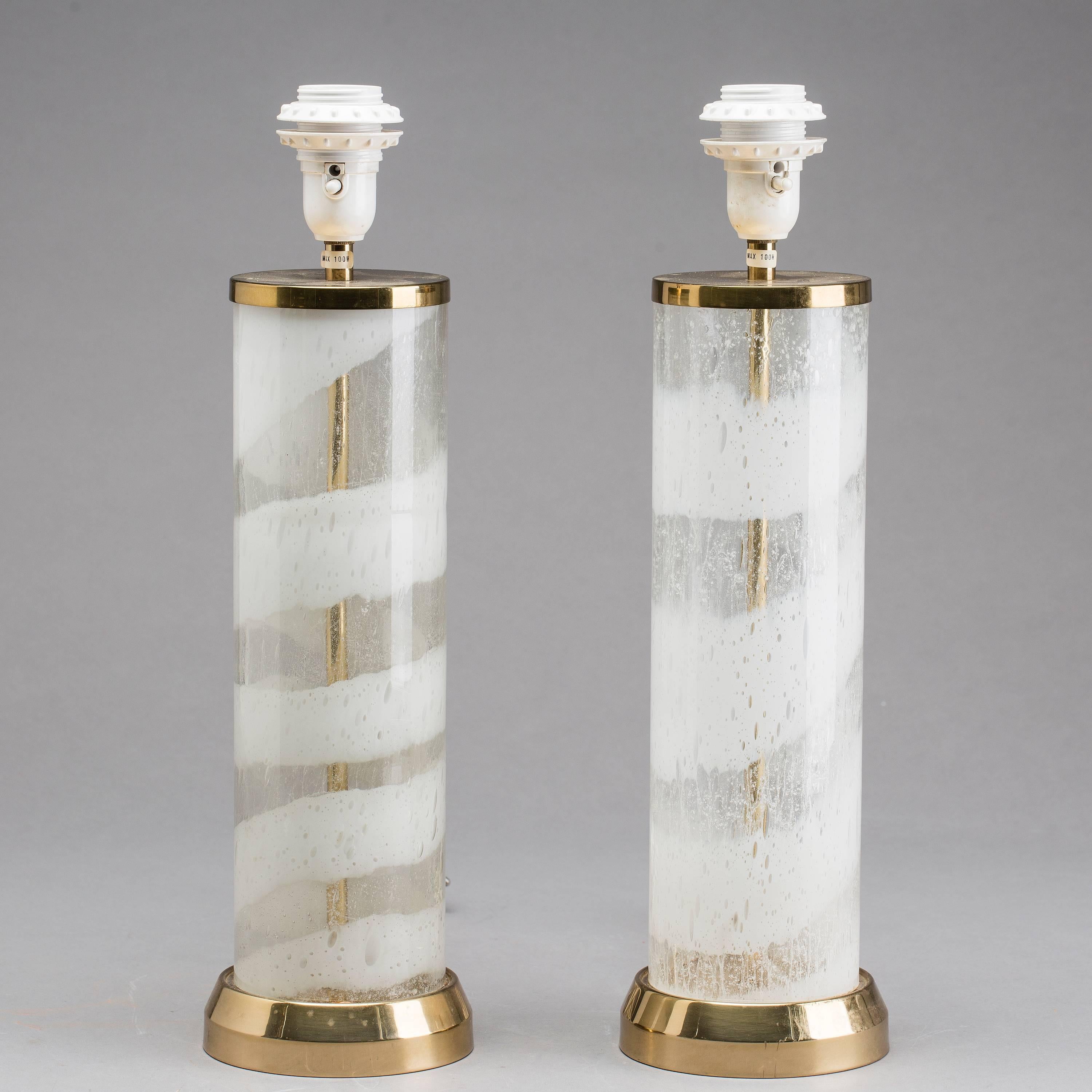 Pair of table lamps by Bergboms, Sweden, circa 1960;
Glass with inclusions of bubbles; white glass, brass.
 