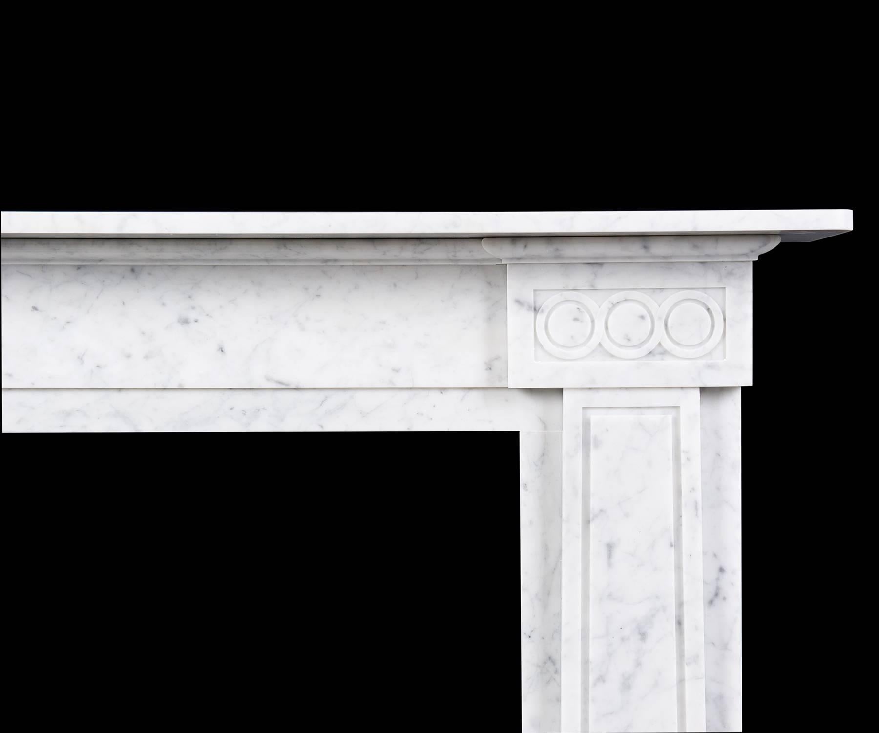 The Cosmopolitan pays homage to the work of Sir John Soane with its modern rendition of inversely tapering pilasters and guilloche ornamented corner blocks combining to create a mantel of an entirely contemporary nature. Carved in Carrara marble.