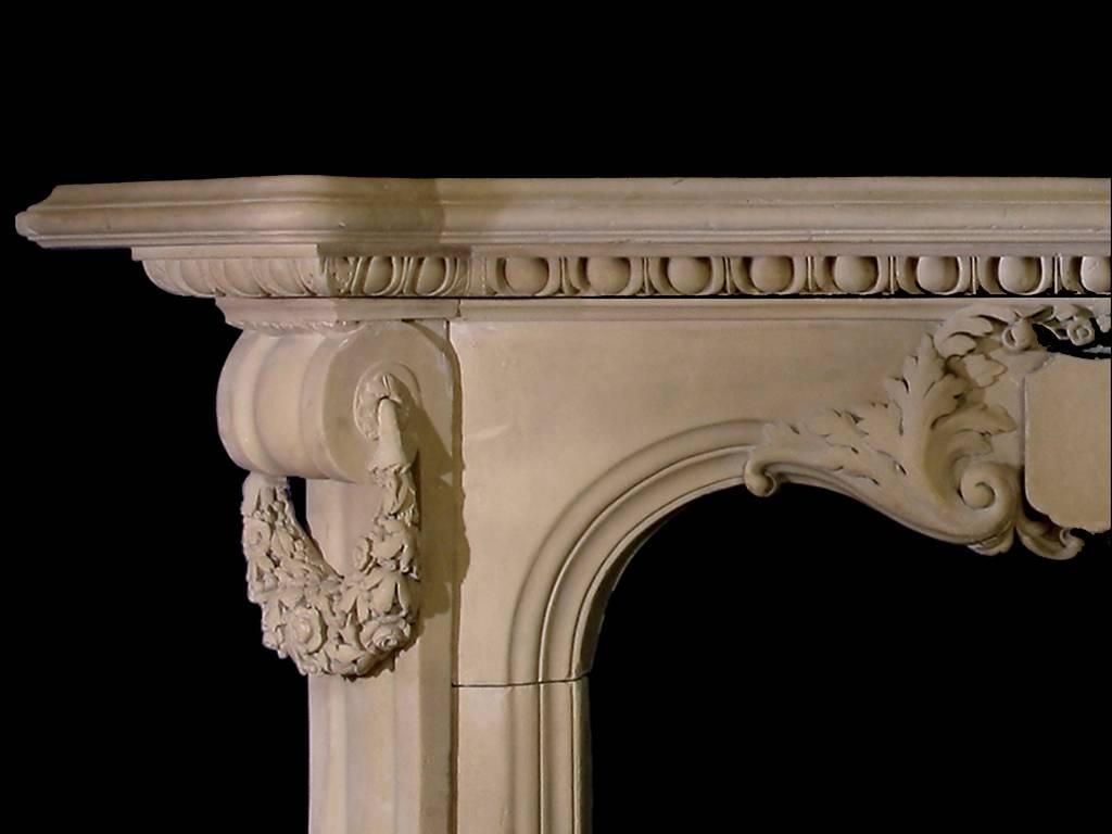 An unusual, early-Victorian carved stone mantel, circa 1840. The mantel has strong console jambs with carved floral wreaths, plain heraldic plaque and acanthus leaf detail across a serpentine frieze.

Opening dimensions: 40
