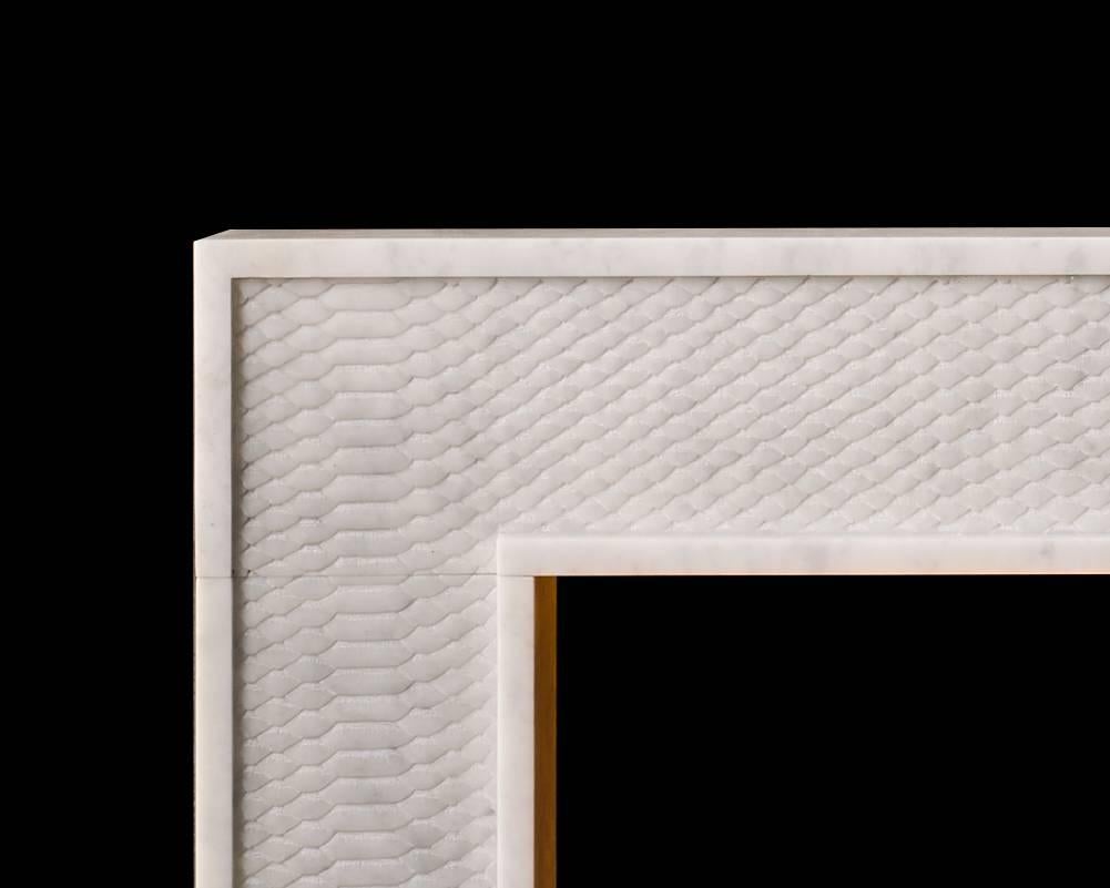 The Python by Alexa Hampton is a modern mantel with beautifully carved detail simulating snake skin. Shown carved in Carrara marble. 

Opening dimensions: 40