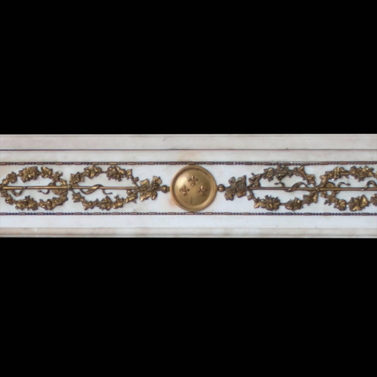 A French Empire style mantelpiece carved in Italian statuary marble with fine ormolu detailing.

Opening dimensions: 48 1/4