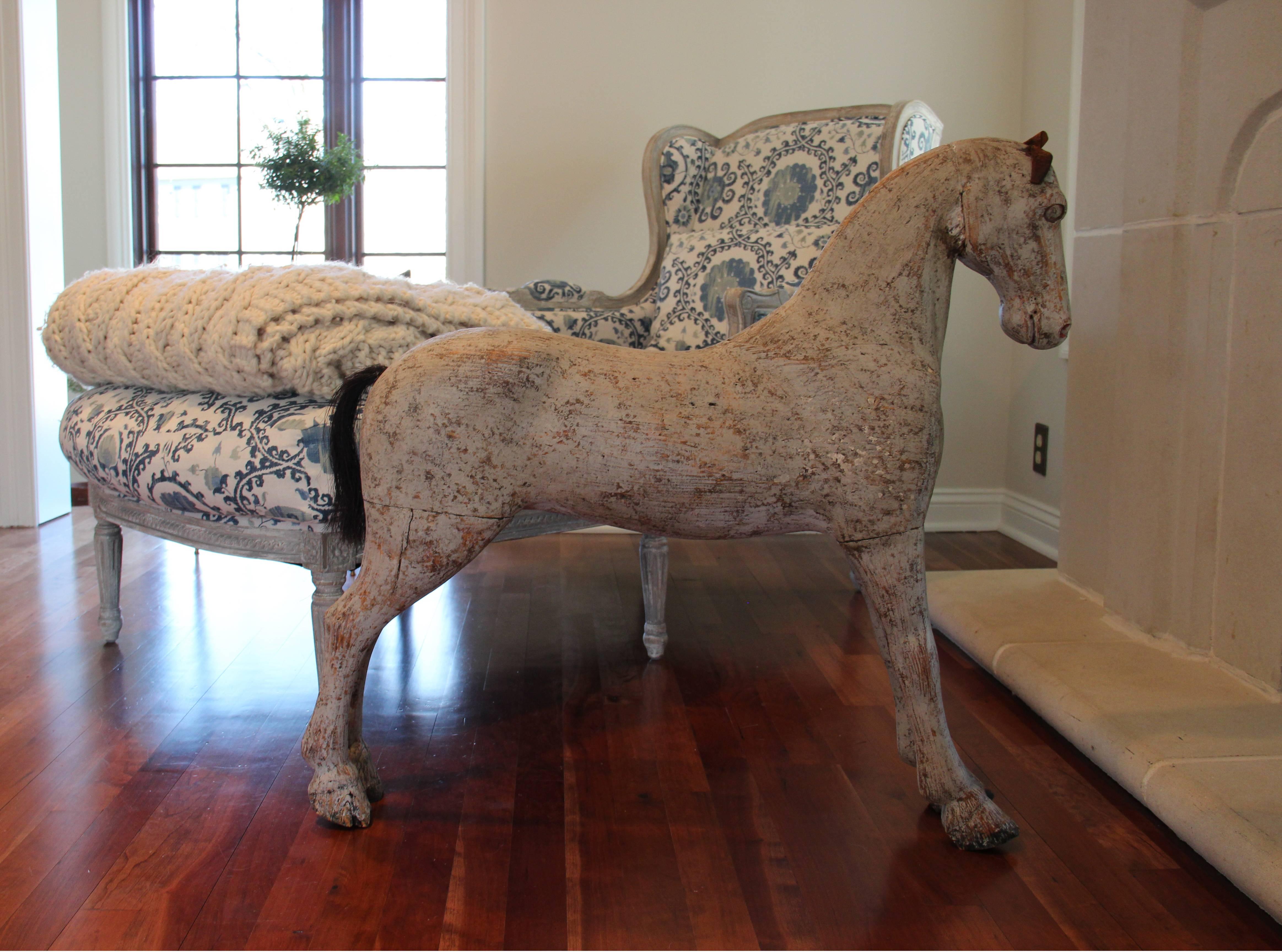 Such a handsome fellow, our Ozzie! A Swedish painted toy horse from the 19th century with original leather ears and horse hair tail. The aged old white or gray patina is stunning.