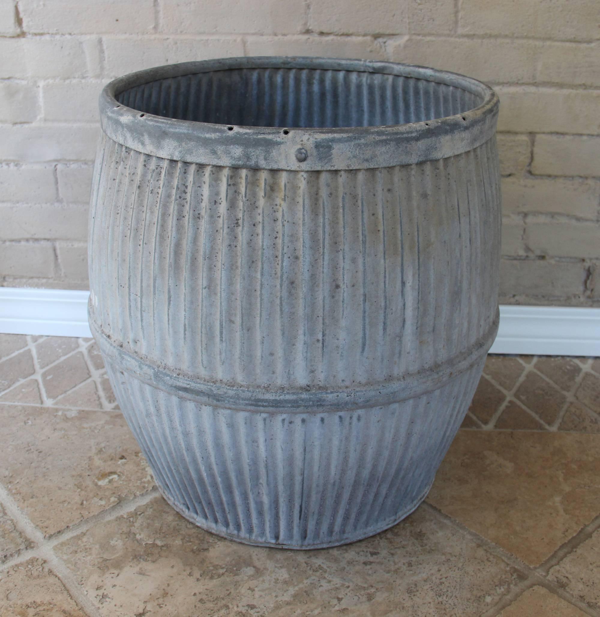 This vintage English Industrial dolly tub is made of galvanized zinc and was originally used for washing clothes. Dolly tubs make wonderful pots for plants. They are perfect for the home or garden.
